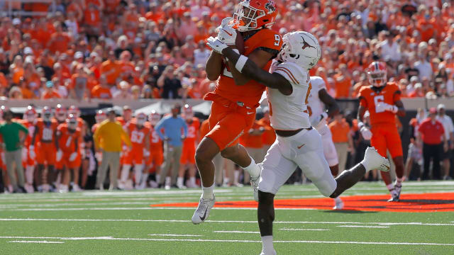 Oklahoma State Cowboys wide receiver Bryson Green (9) catches a pass in front of Texas Longhorns defensive back D'Shawn Jamison (5) during a college football game between the Oklahoma State Cowboys (OSU) and the University of Texas Longhorns at Boone Pickens Stadium in Stillwater, Okla., Saturday, Oct. 22, 2022. Oklahoma State won 41-34.